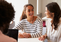 student smiling at parent